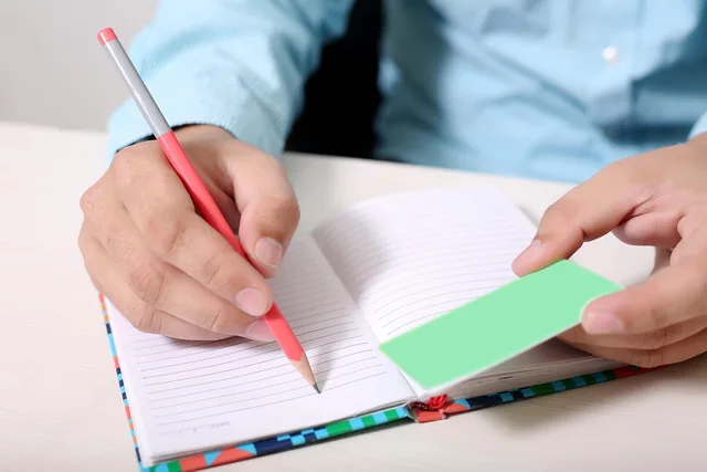 boy, man, card, hand, people, person, male, adult, portrait, young, notebook, copy, write, holding, pencil, paper, sheet, table, desk, wooden, page, blank, writing, work. Magazine copy editing: a practical guide to clean, accurate copy