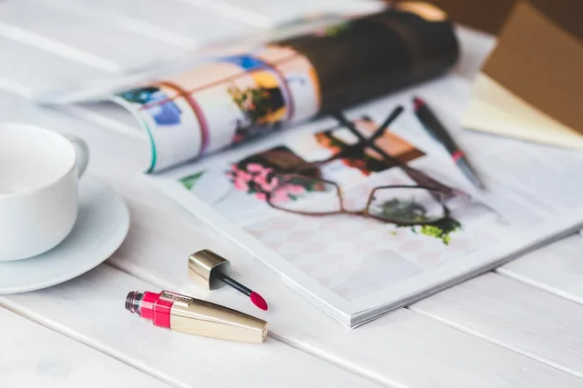 red, lipgloss, lip gloss, lipstick, coffee cup, coffee, cup, white, makeup, make-up, make up, girly, desk, glasses, newspaper, magazine, lifestyle, style, accessories. Pitch, contributor brief, assignment letter, and contract compared